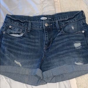 small ripped dark wash blue jeans